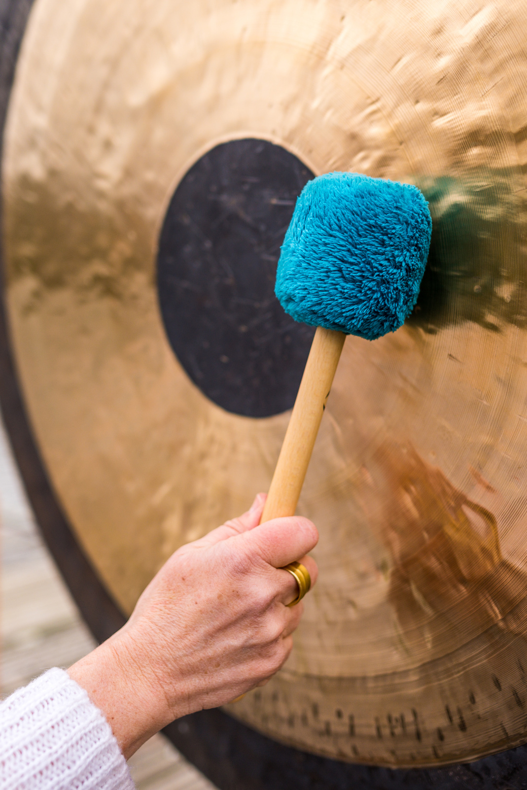 gong meditation, Hand holds a mallet and beats a gong